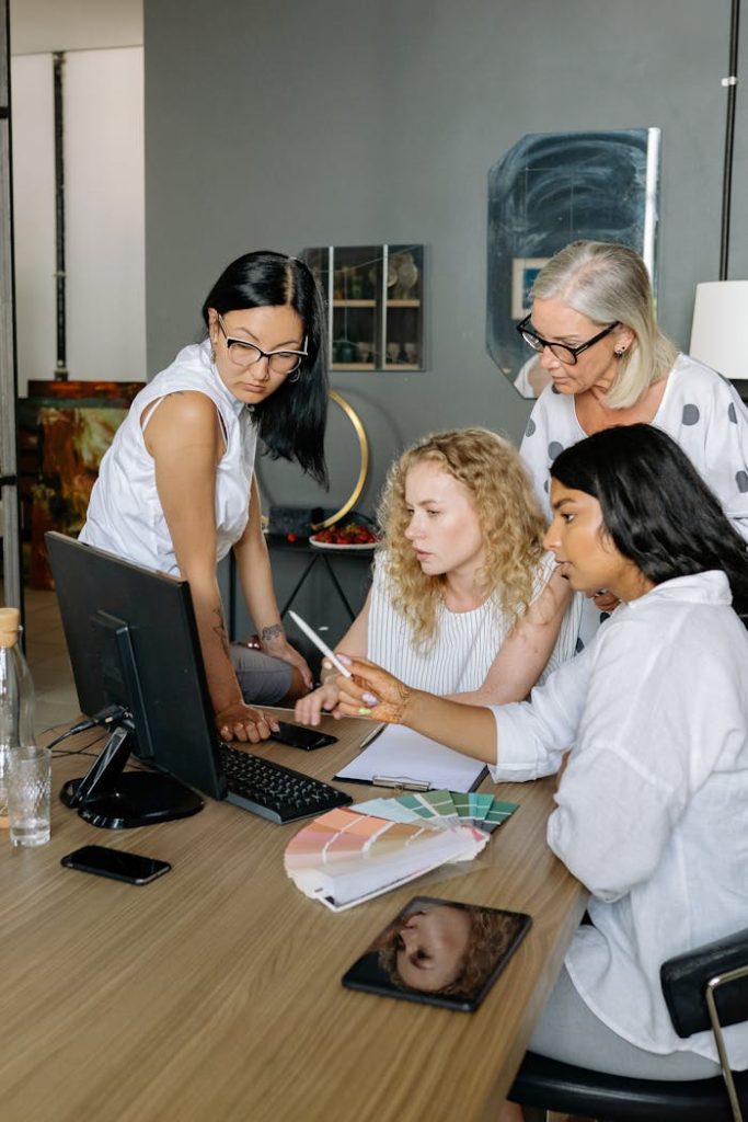 women-looking-at-the-screen-of-a-computer-8837376 Women Looking at the Screen of a Computer